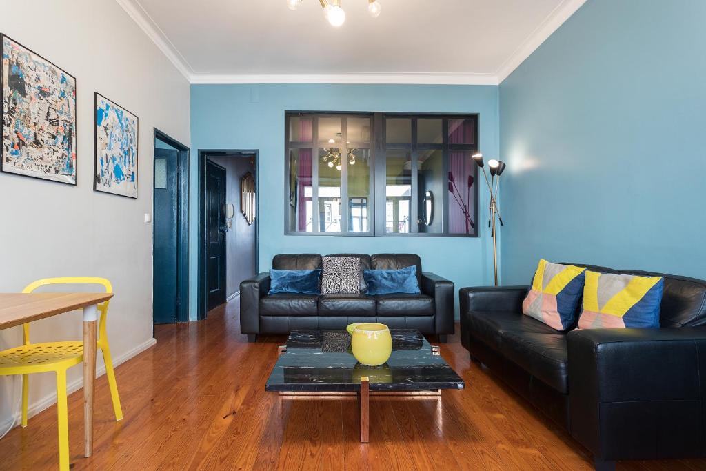 a living room with a couch and a table at Chiado Bairro Alto, Bright and Newly Renovated 3 Bedroom Apartment, Lisbon Historical Center in Lisbon