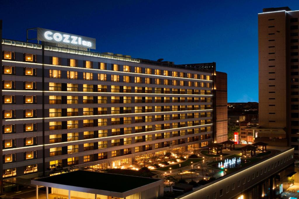 a lit up building with a sign on top of it at Hotel COZZI Ximen Tainan in Tainan