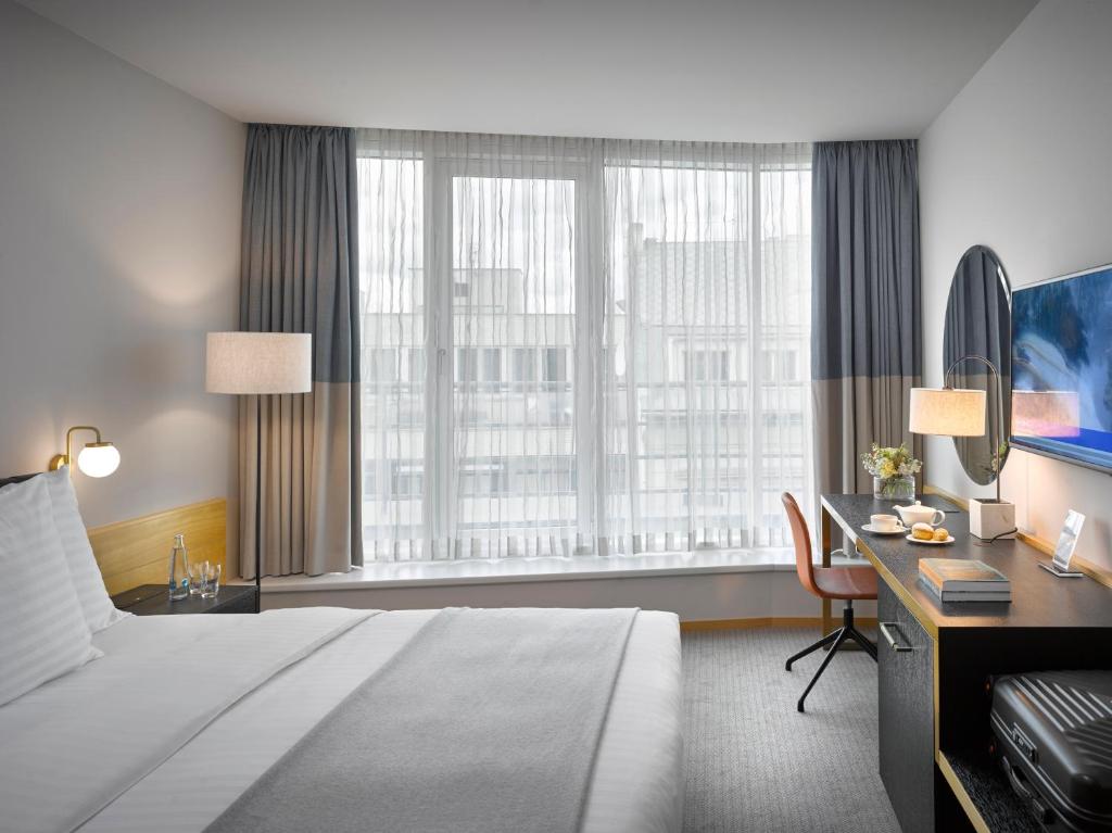 Postel nebo postele na pokoji v ubytování K+K Hotel Fenix
