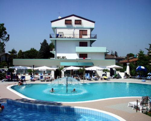 a large swimming pool in front of a building at Oasi Verde in Lido di Jesolo