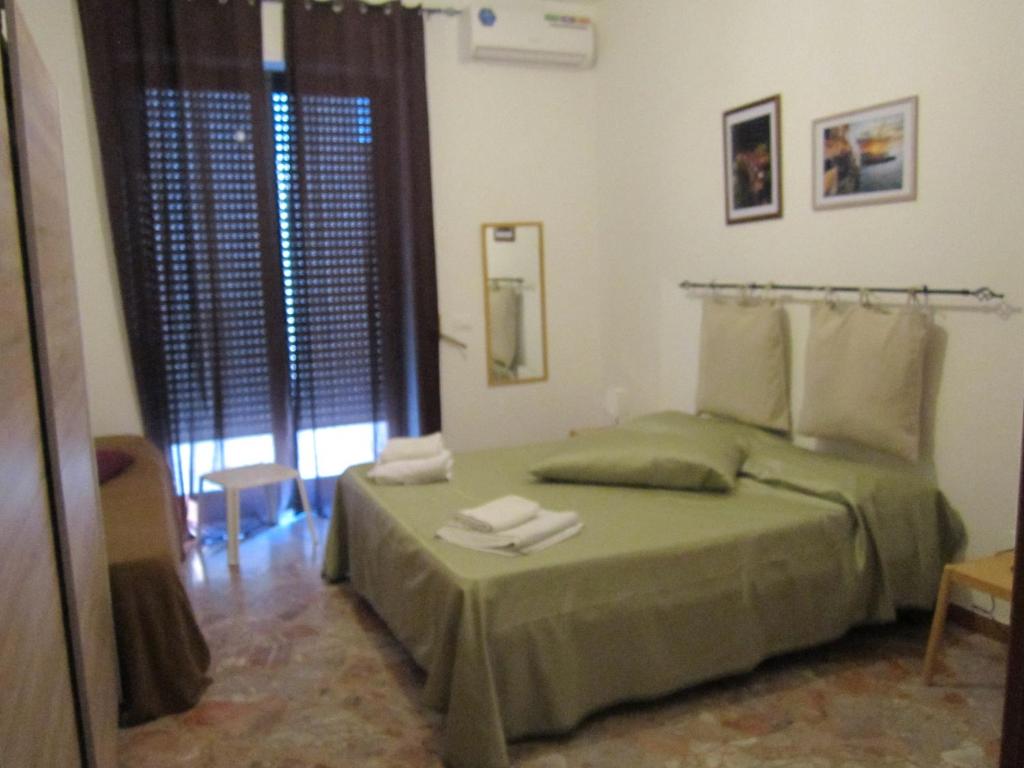 Un pat sau paturi într-o cameră la Casa Raffaella