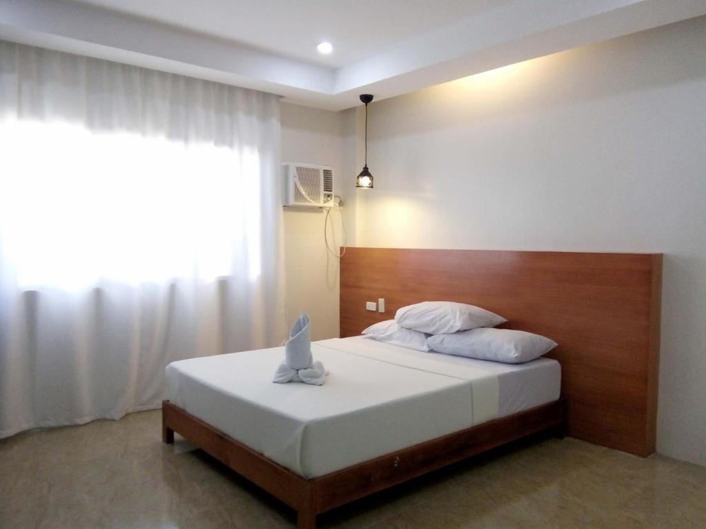 Ένα ή περισσότερα κρεβάτια σε δωμάτιο στο La Casa Teresa Tourist Inn Inc