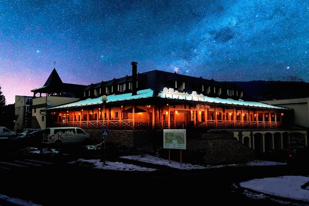 a building with christmas lights on it at night at Penzión Adrián in Bardejov