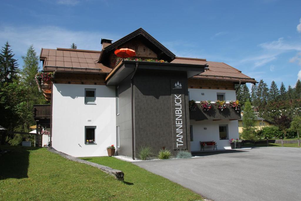 a building with a sign on the side of it at Ferienhaus Tannenblick in Leutasch