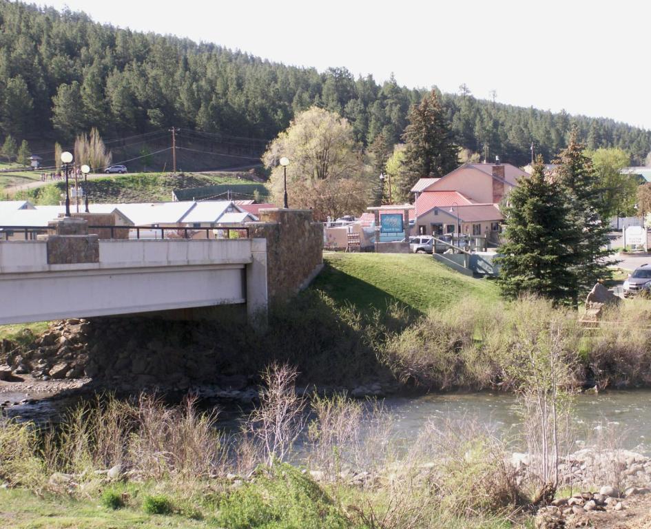 a bridge over a river next to a town at Healing Waters Resort and Spa in Pagosa Springs