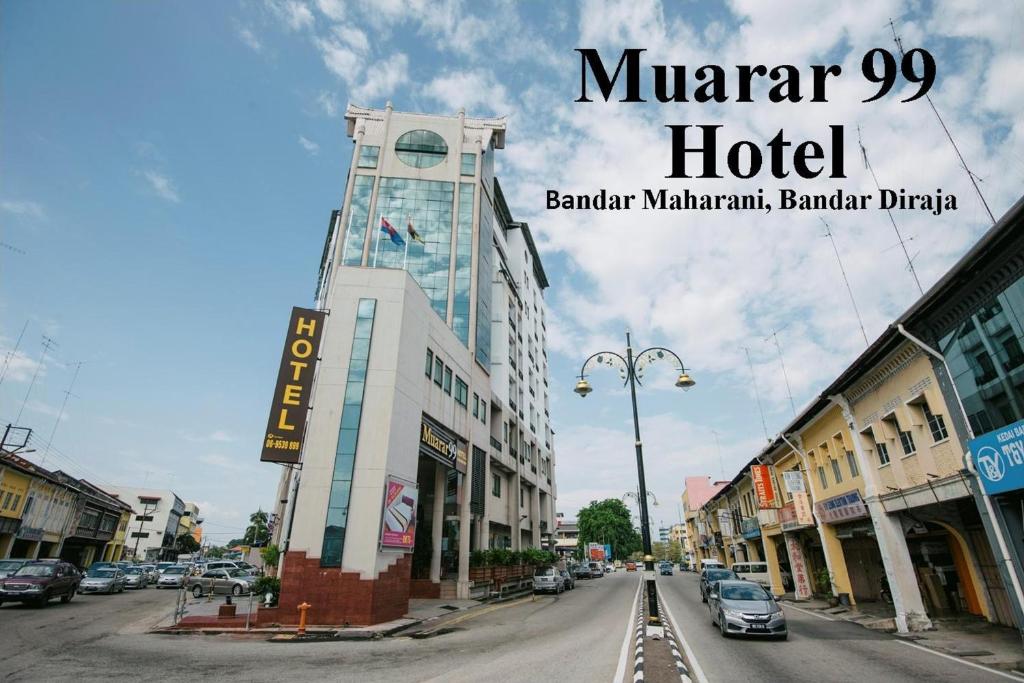 a sign for a hotel on a city street at Muarar 99 Hotel in Muar