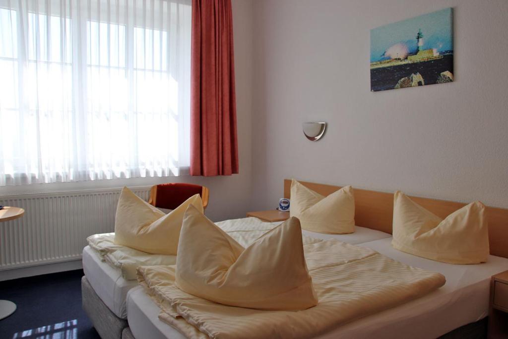 Postel nebo postele na pokoji v ubytování Hotel Garni Meeresgruß