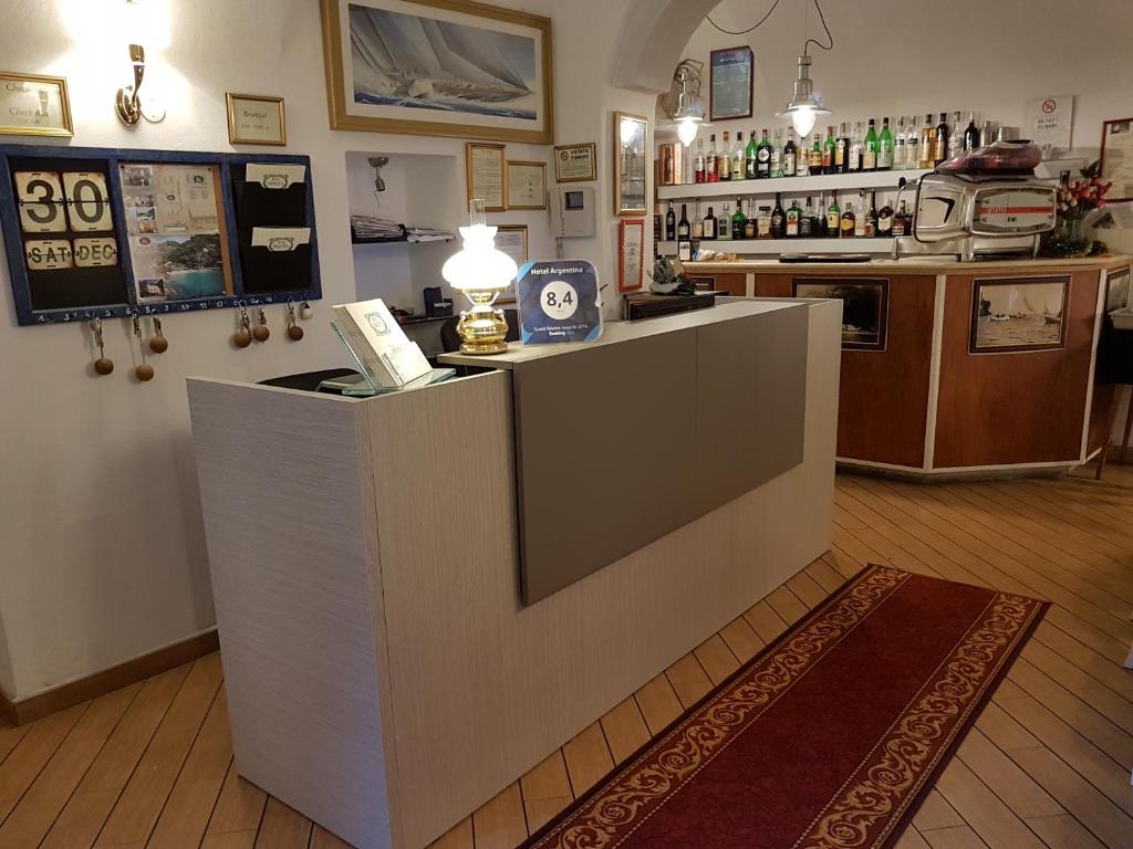 a bar with a counter in a room with a kitchen at Hotel Argentina in Santa Margherita Ligure