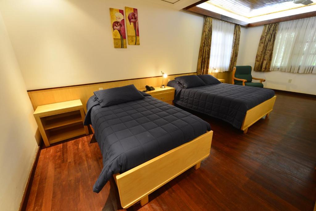Letto o letti in una camera di Hotel Restaurant Papillon