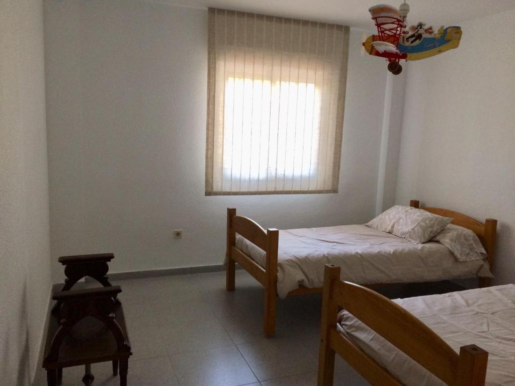 Łóżko lub łóżka w pokoju w obiekcie Apartamento Elia Villa África