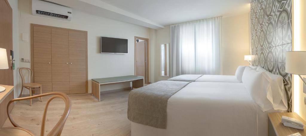 Postel nebo postele na pokoji v ubytování Gastrohotel Boutique RH Canfali