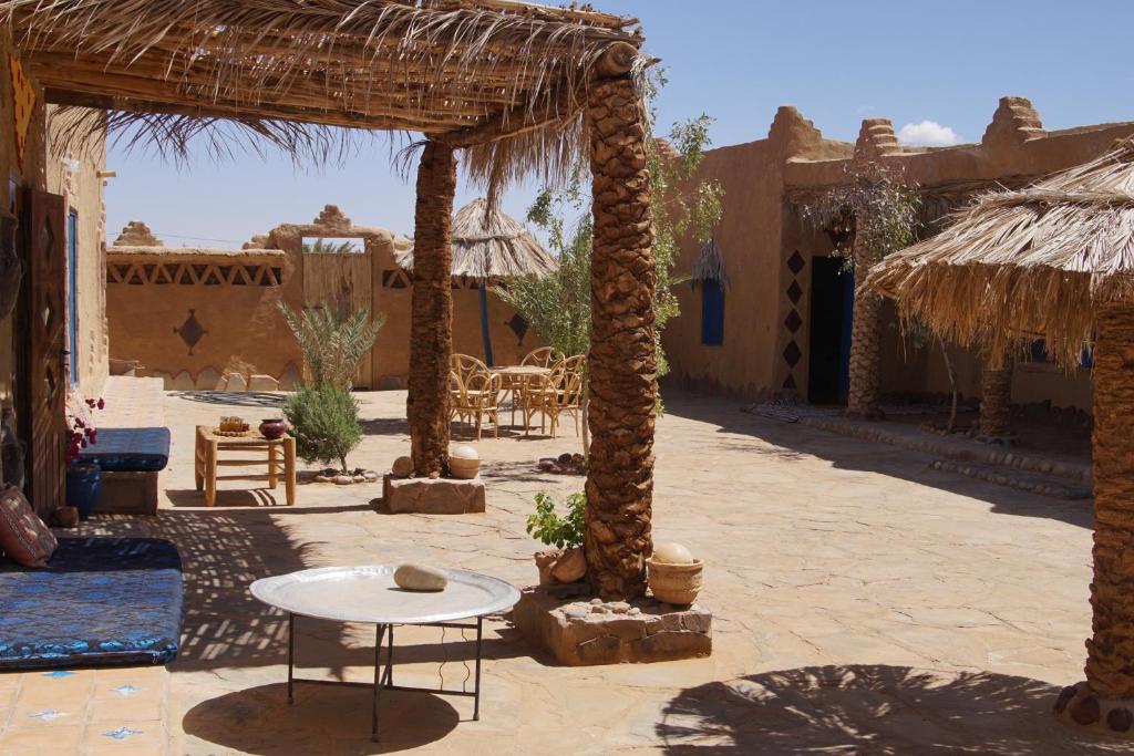 an outdoor patio with a table and a pavilion at Kasbah Luna del Sur in Merzane