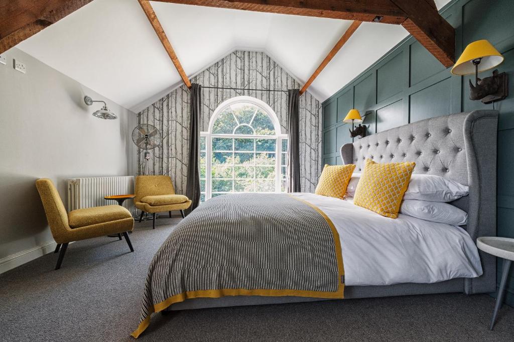 a bedroom with a bed and a table and chairs at The Coach House in Derby