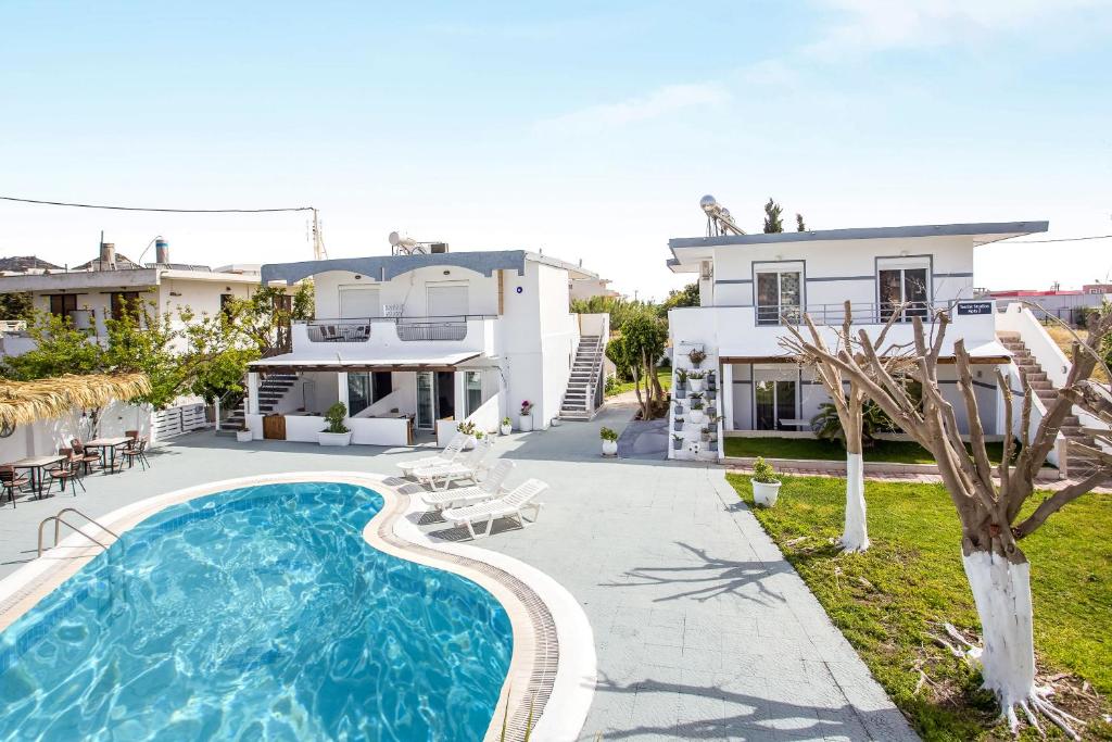 Villa con piscina frente a una casa en Toulas Studios & Apts No2, en Faliraki