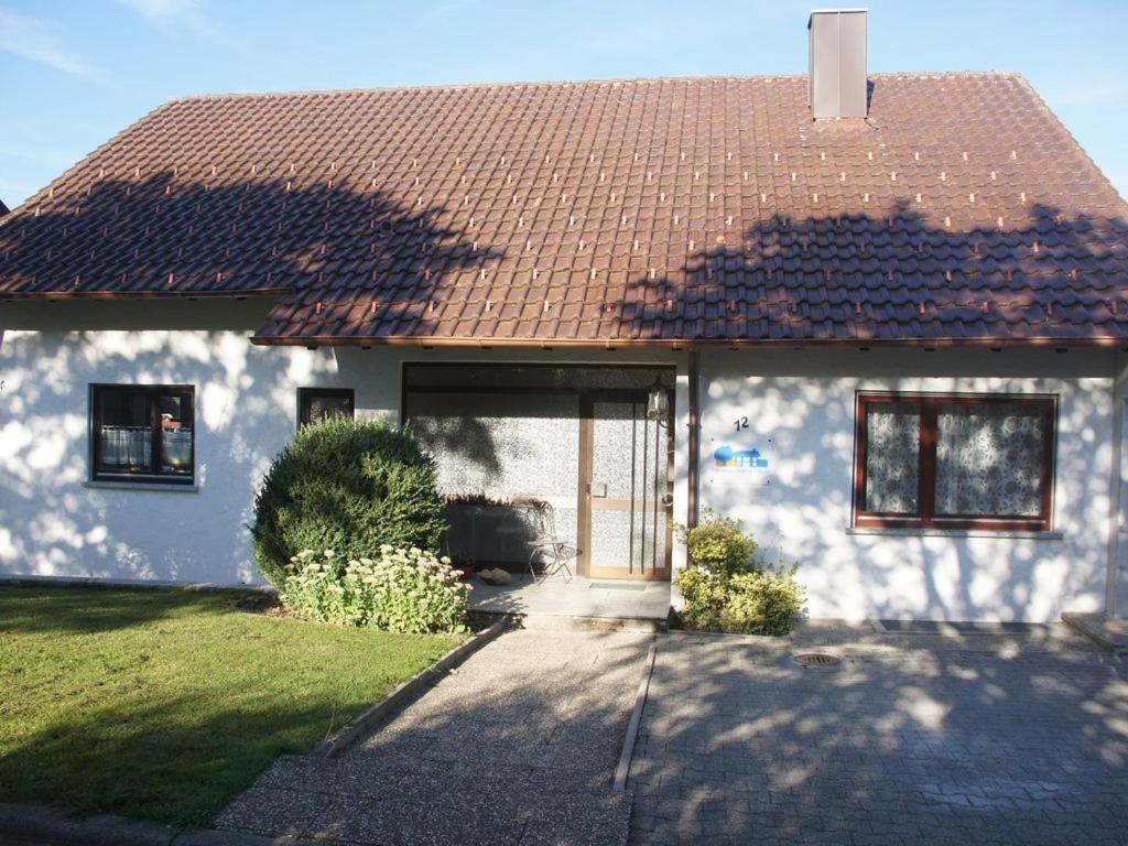 a white house with a brown roof at Ferienwohnung Mayer in Albstadt