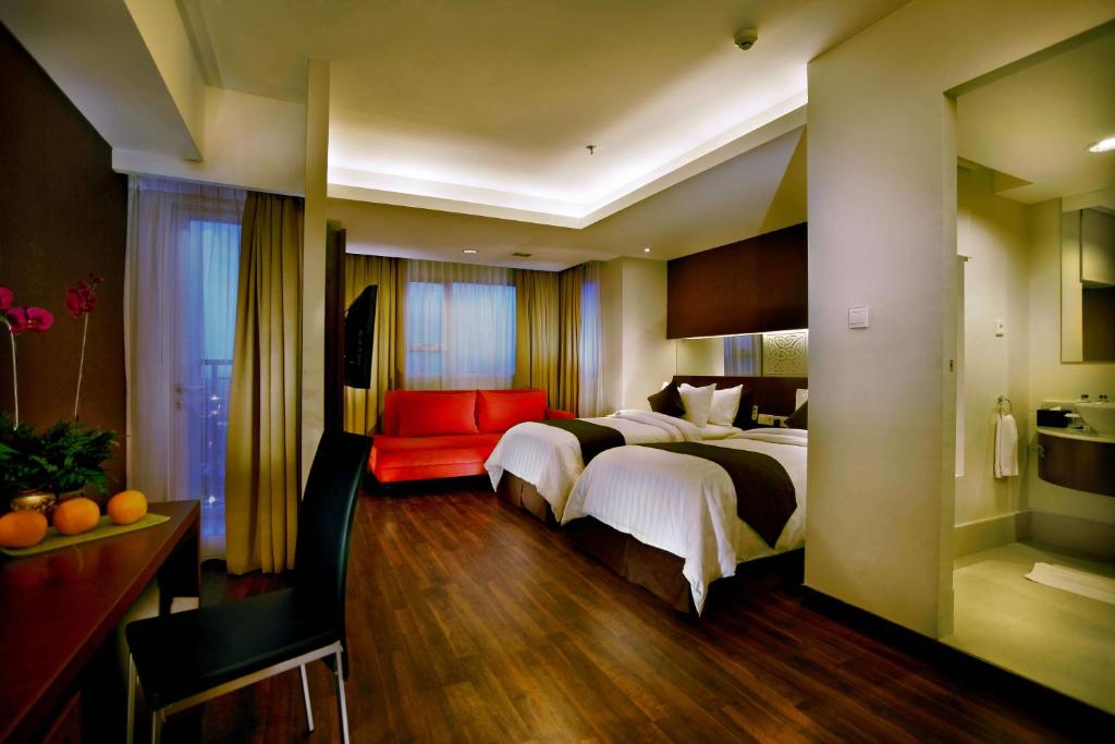 Postel nebo postele na pokoji v ubytování ASTON Pluit Hotel & Residence