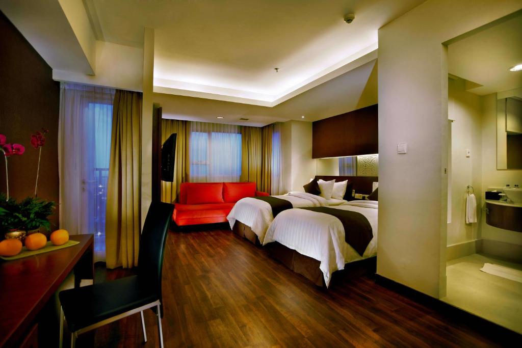 Säng eller sängar i ett rum på ASTON Pluit Hotel & Residence
