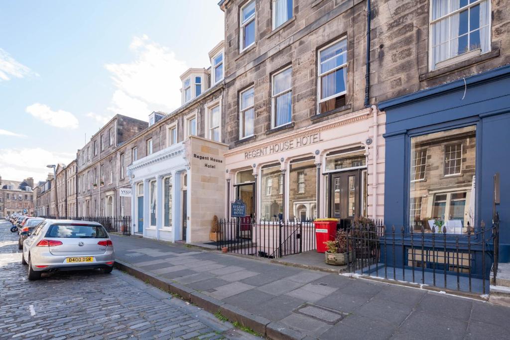 a car parked on a street in front of buildings at Regent House Hotel - City Centre Hotel in Edinburgh