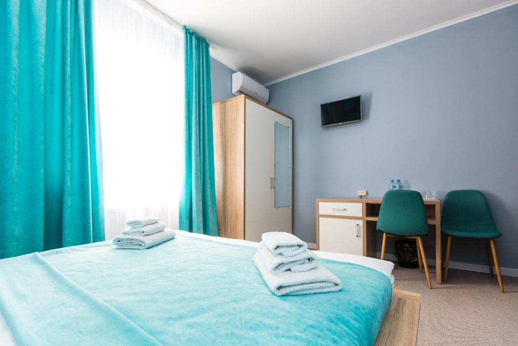 Ліжко або ліжка в номері Blum Hotel