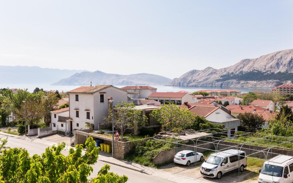 a city with cars parked in a parking lot at King's Apartment in Baška