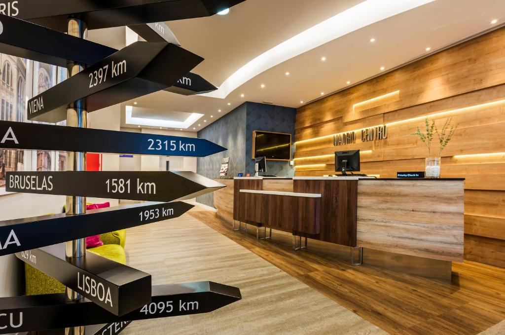 a lobby with signs on the wall and a desk at Hotel Madrid Centro, Affiliated by Meliá in Madrid