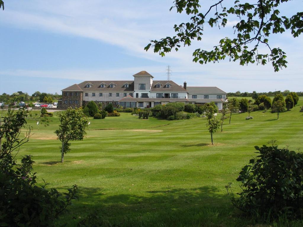 a large house on a lush green field at Bowood Park Hotel in Camelford