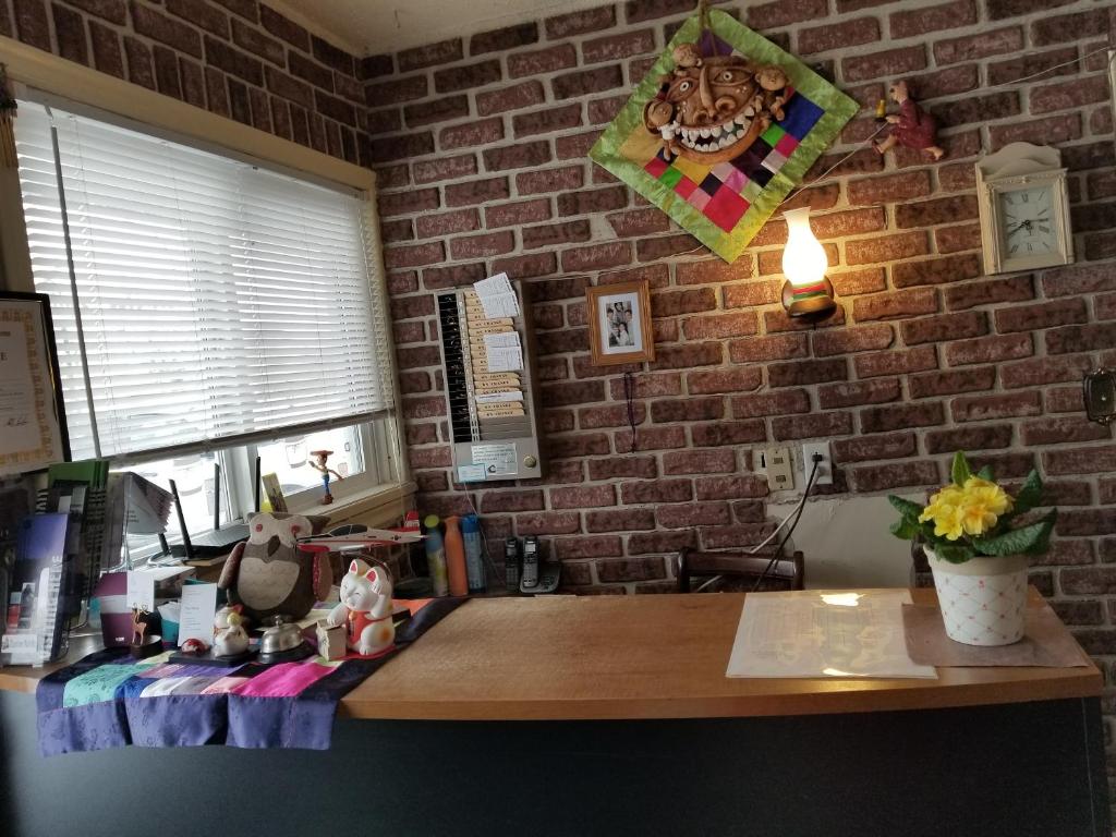 a room with a brick wall and a wooden desk at Melsask Motel in Melville