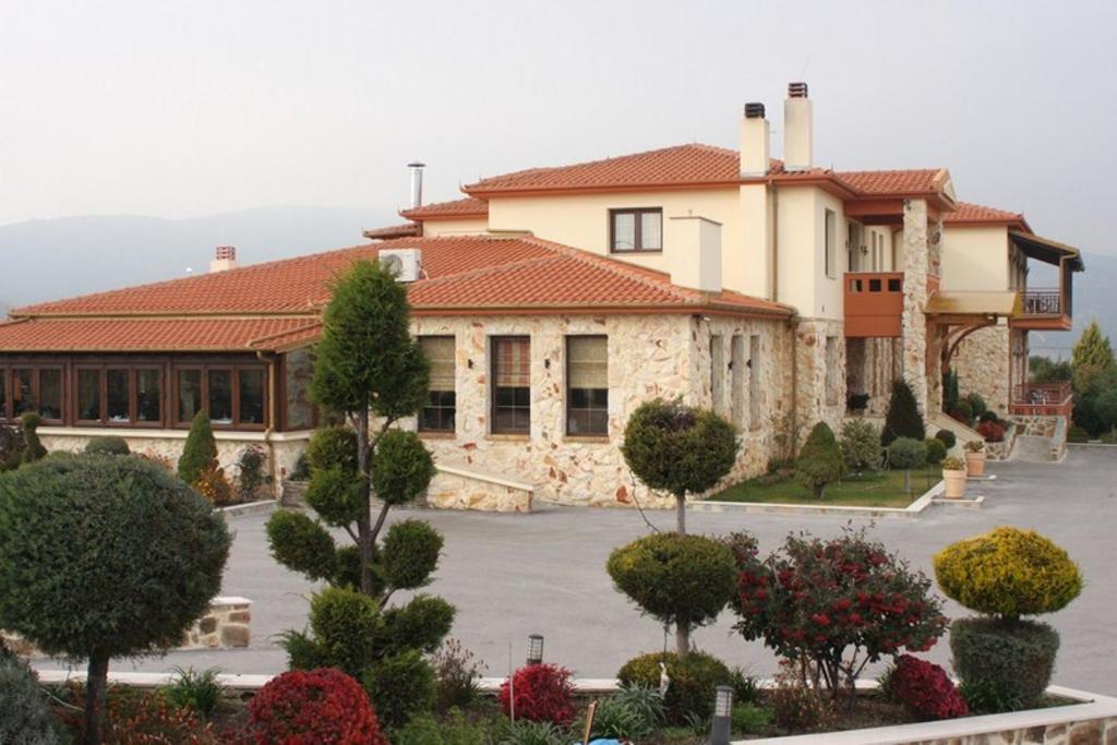 a large building with a parking lot in front of it at Lozitsi in Veria