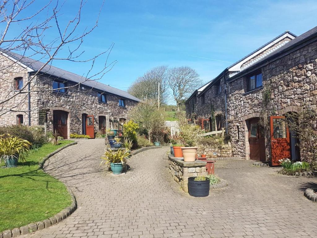 a stone building with a walkway in front of it at King's Head Inn in Llangennith