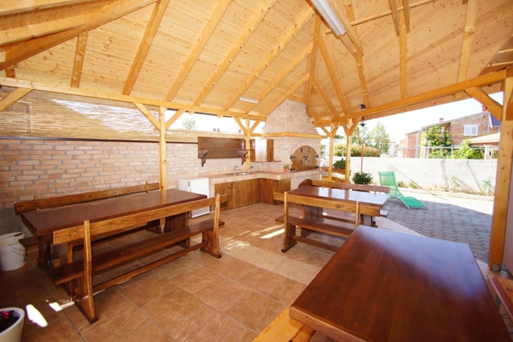 a large open kitchen with wooden tables and benches at Apartments Nešić Peroj in Fažana