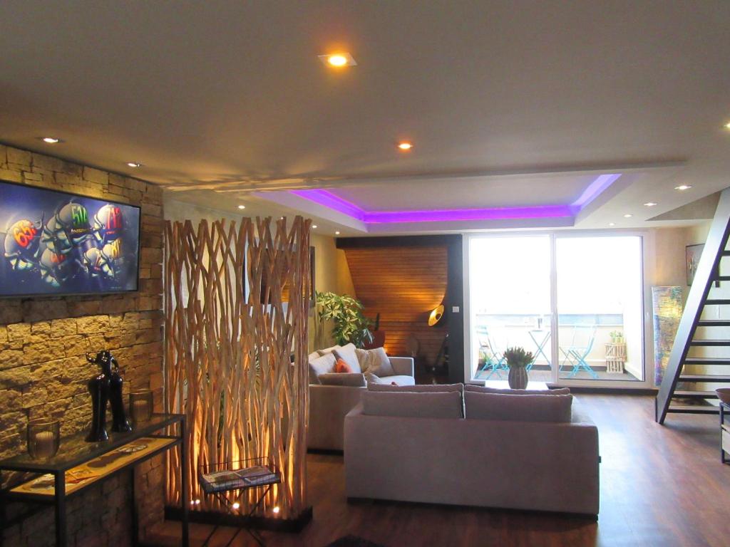 a living room with a couch and a stone wall at ville close in Concarneau