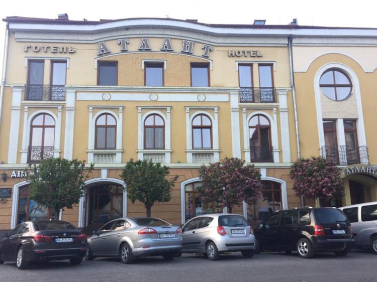 a group of cars parked in front of a building at Atlant Hotel in Uzhhorod