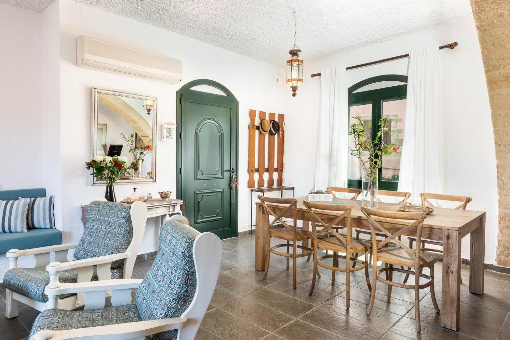 a dining room with a table and chairs at Traditional Sea Side Cottage in Maleme