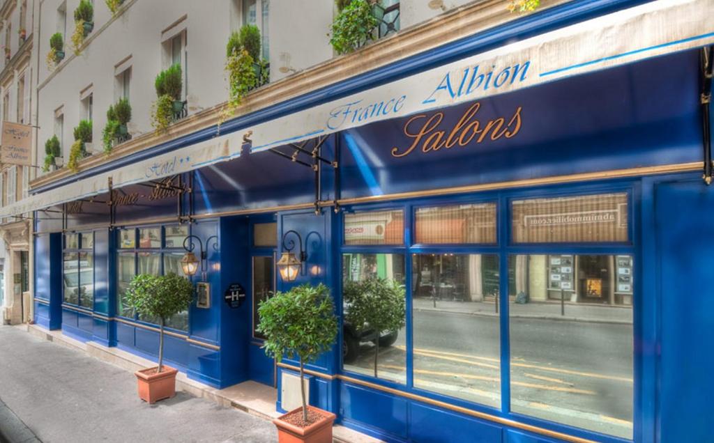 un edificio azul al lado de una calle en Hotel France Albion en París
