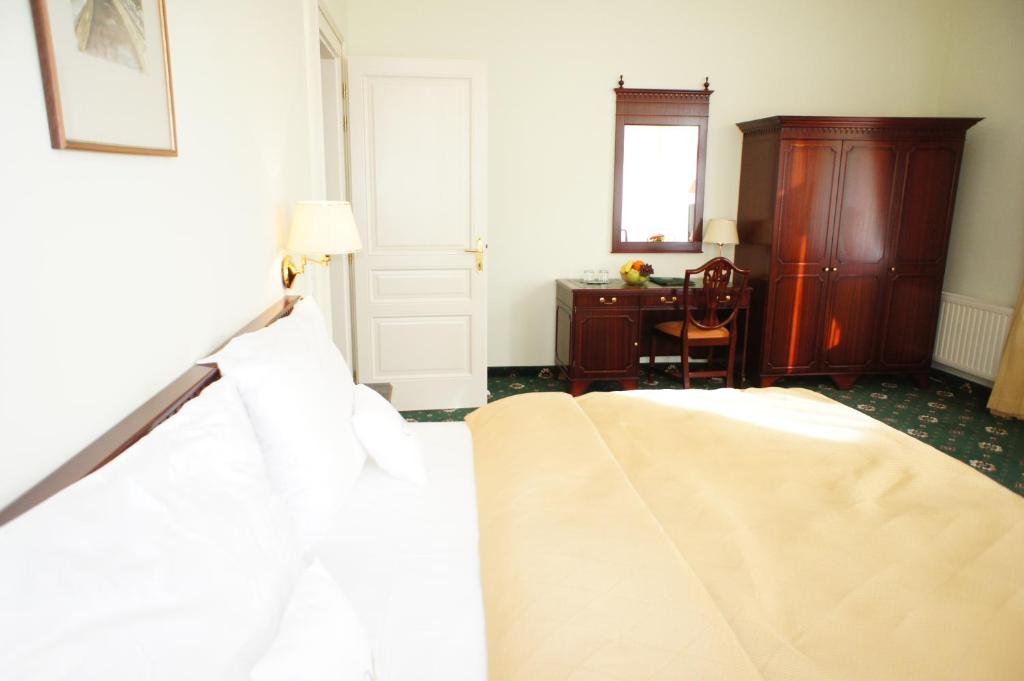 Postel nebo postele na pokoji v ubytování Hotel Mignon