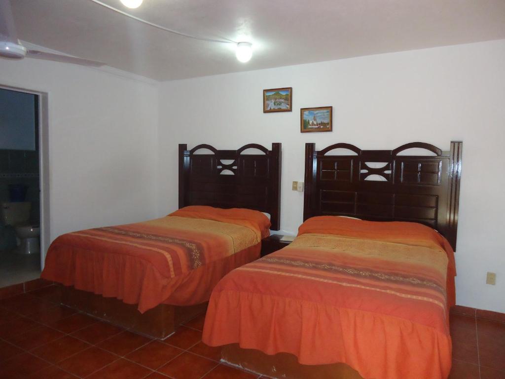 Postel nebo postele na pokoji v ubytování Hotel San Isidro