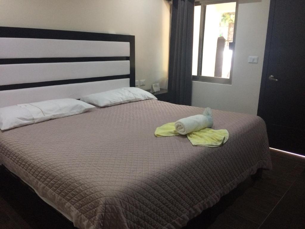 Postel nebo postele na pokoji v ubytování Hotel Sevilla Palenque