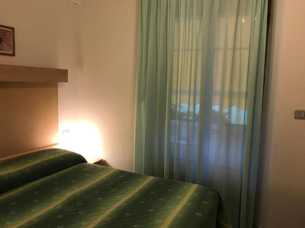 Postel nebo postele na pokoji v ubytování Hotel B&B Rispescia Grosseto