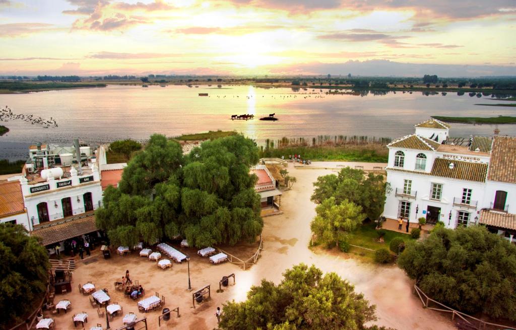 an aerial view of a town with a river and buildings at Hotel Restaurante Toruño in El Rocío