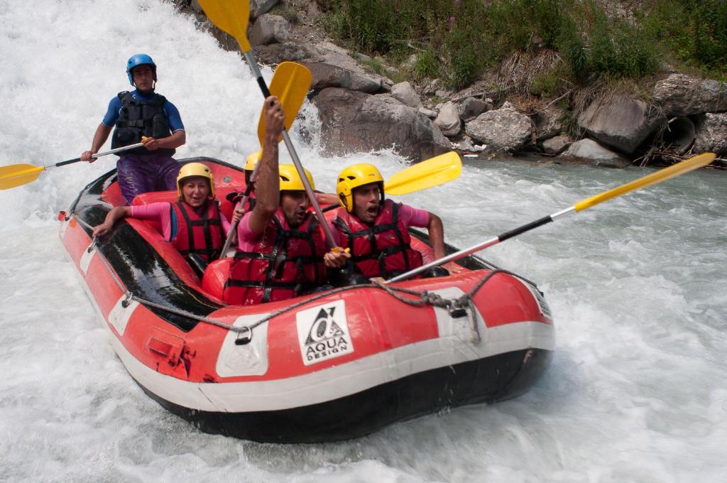 a group of people in a raft in a river at Rock Noir & Spa in La Salle-les-Alpes