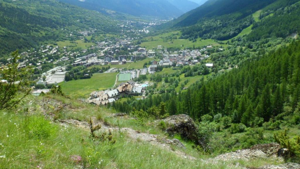 a view of a town from a mountain at Rock Noir & Spa in La Salle-les-Alpes