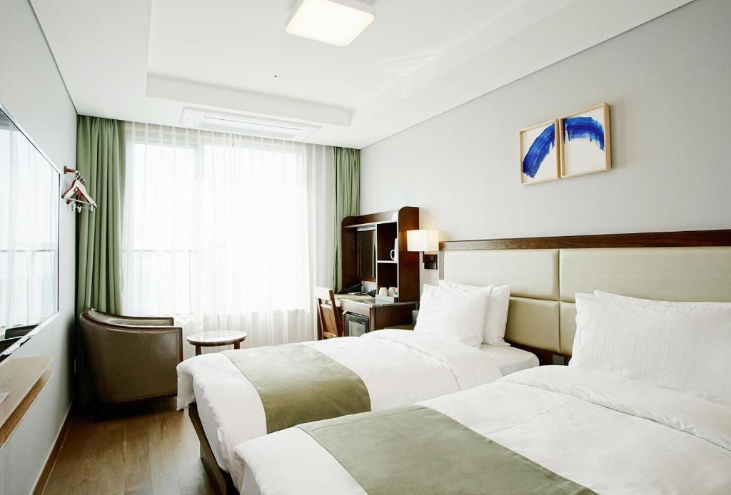 Postel nebo postele na pokoji v ubytování Stanford Hotel Busan