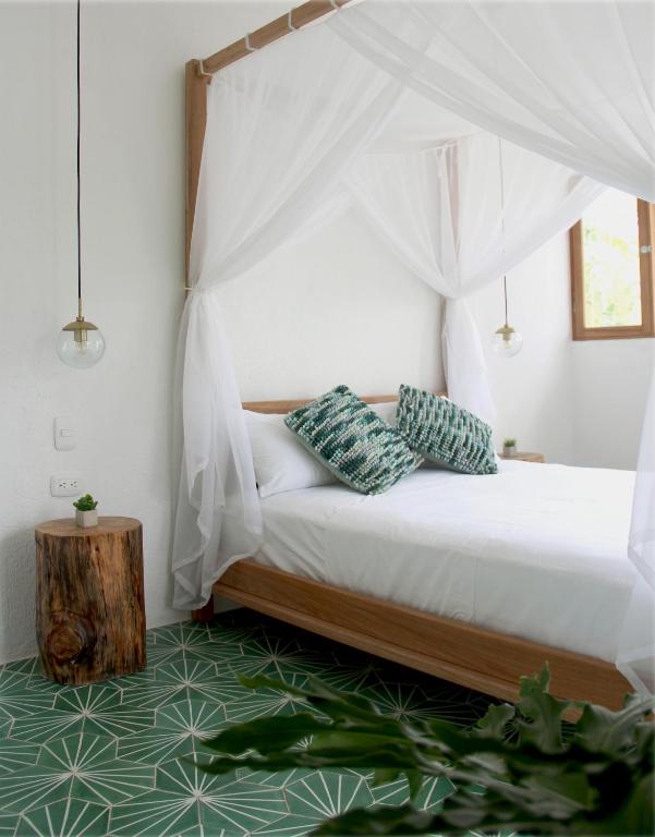 Postel nebo postele na pokoji v ubytování Casa del Pavo Real Boutique Hotel