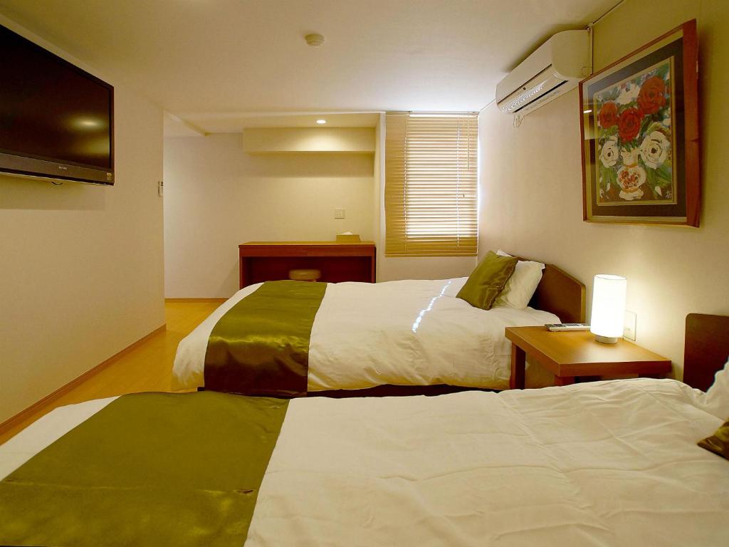Letto o letti in una camera di Atami Onsen Hotel Yume Iroha