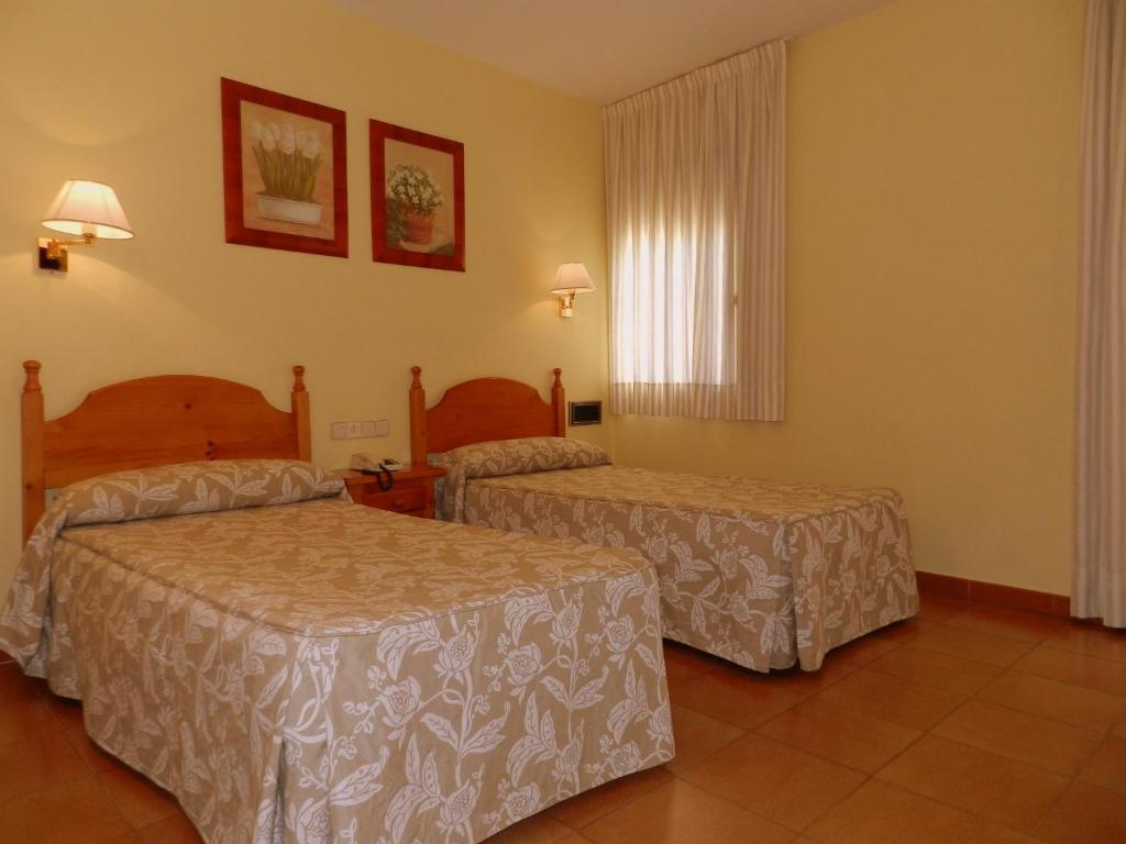 Postel nebo postele na pokoji v ubytování Hotel Ostau d'Òc