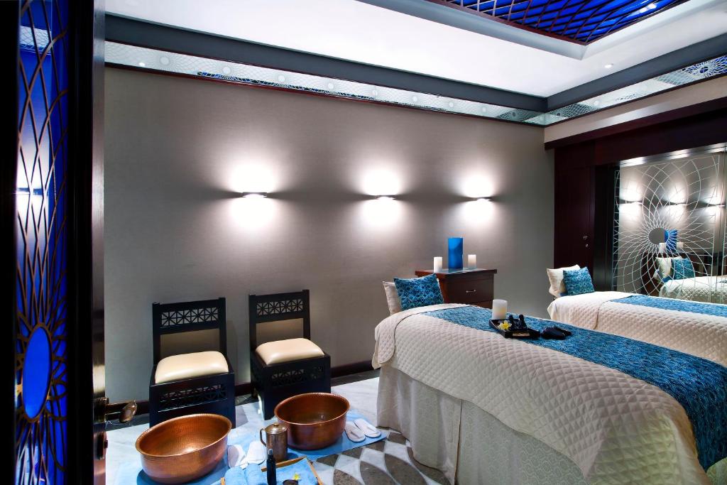 a room with two beds and two stools at Bab Al Qasr Residence in Abu Dhabi