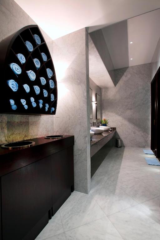a bathroom with a sink and a large pendant light at Bab Al Qasr Residence in Abu Dhabi