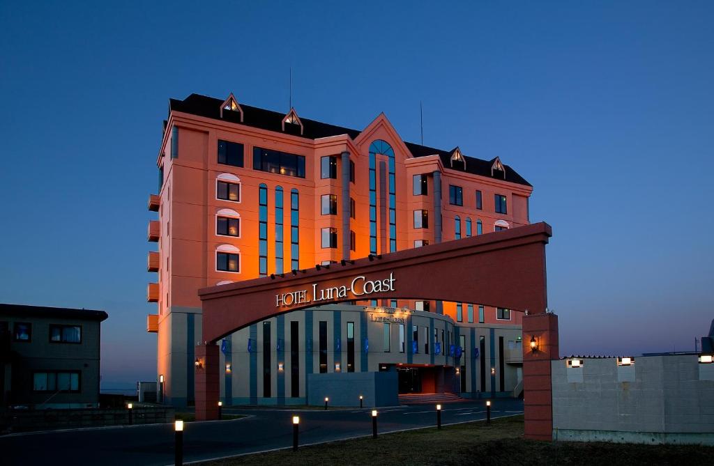 een groot oranje gebouw met een bord erop bij Hotel Luna Coast (Adult Only) in Otaru