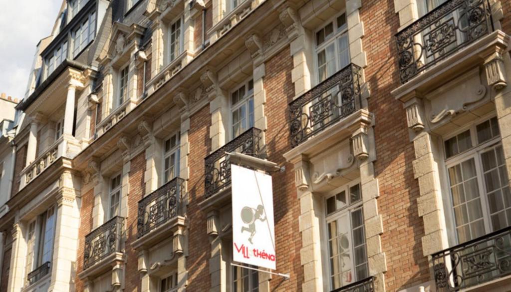 a sign on the side of a brick building at Villathena in Paris