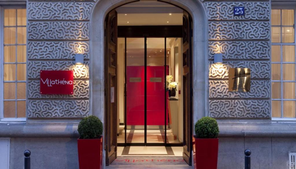 a entrance to a building with a red door at Villathena in Paris